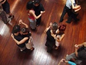 Group of people social dancing in a club.